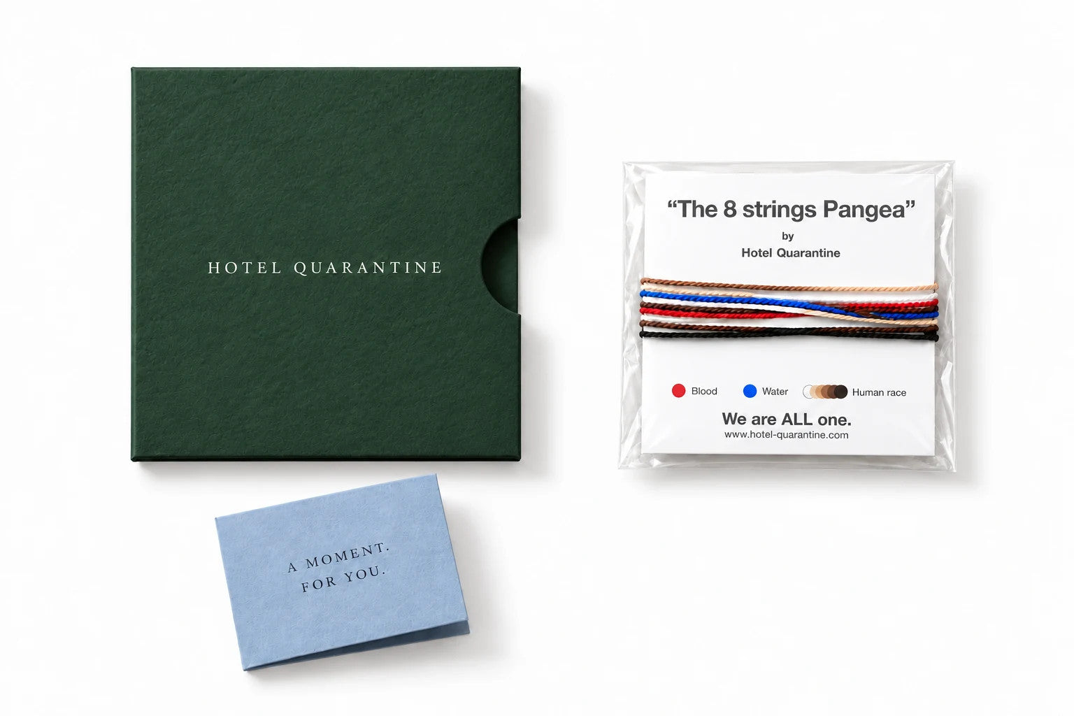 The original Pangea bracelet and printed card in their clear protective sleeve, beside a green Hotel Quarantine paper pocket and small dusty blue note, on a white background.